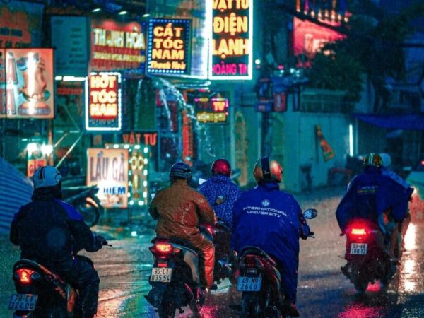 Motociclistas debaixo de chuva usando capa